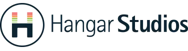 The official logo for Hangar Studios. It features a circular emblem on the left containing a stylized dark navy letter "H." The vertical bars of the "H" are topped with colorful horizontal lines resembling an audio equalizer in green, orange, and red. To the right, the words "Hangar Studios" are written in a clean, professional navy sans-serif font against a white background.