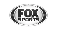 - The official logo for Fox Sports in a dark blue and silver color scheme. The design features the word "FOX" in large, bold dark blue capital letters above the word "SPORTS" in a smaller sans-serif font. The text is centered within a glossy, 3D oval emblem with metallic silver and navy blue outlines, set against a solid white background.